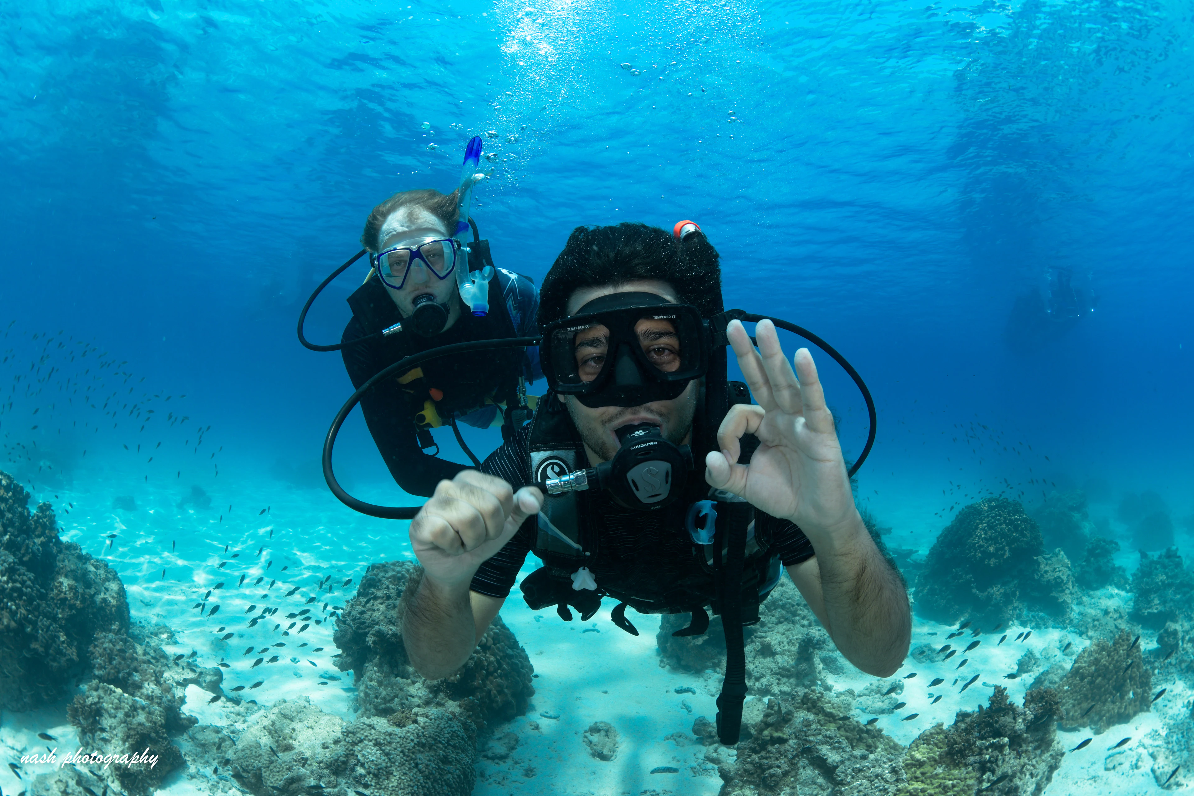 Divers giving the OK sign during a PADI course